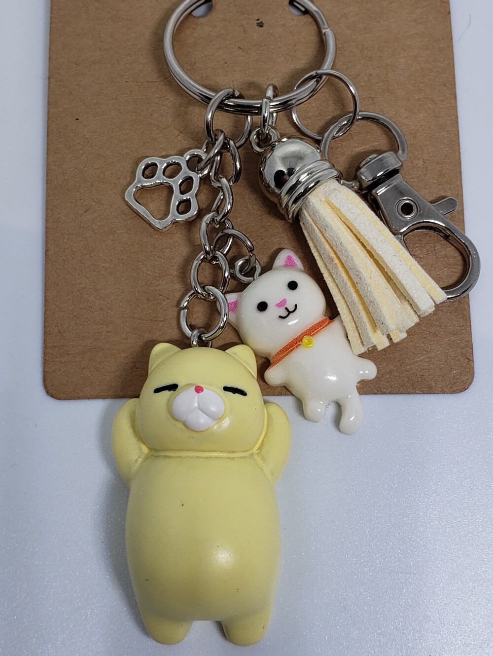 Handmade painted resin white yellow creme cat paw keychain
